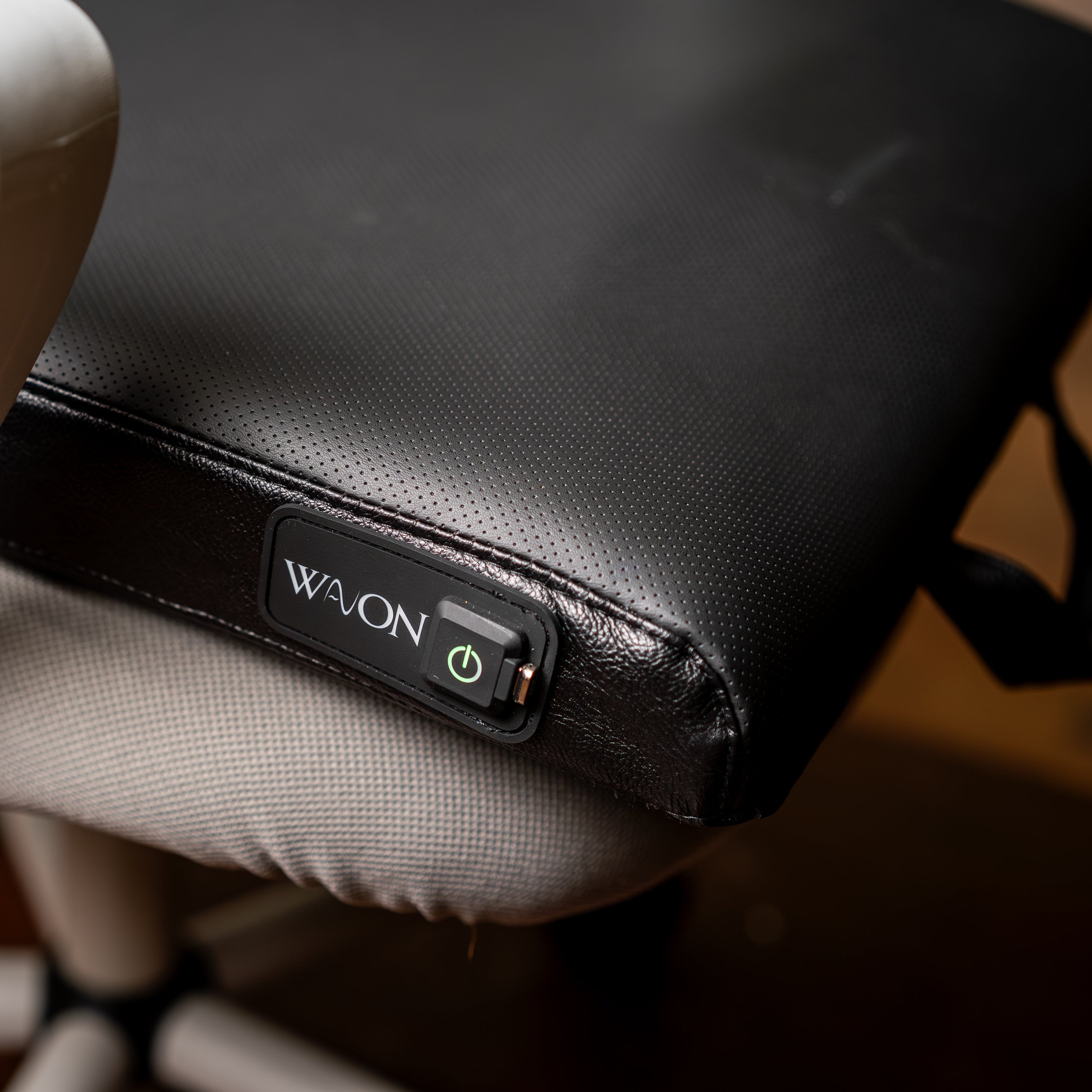 Close-up of a VEGAN LEATHER COVER with a 'WAVON' logo on a blurred background