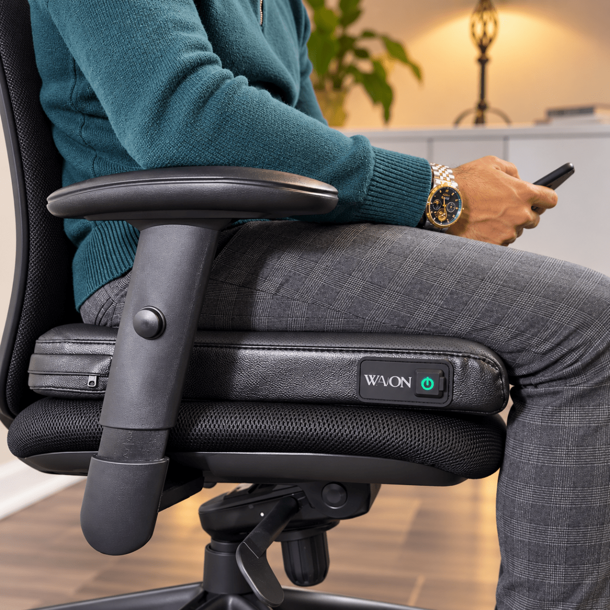 Wavon active seat on a desk next to a phone showing the Wavon app