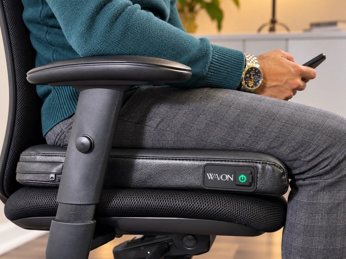 Classic Black: a man sitting on a Wavon on a mesh office chair [In use]